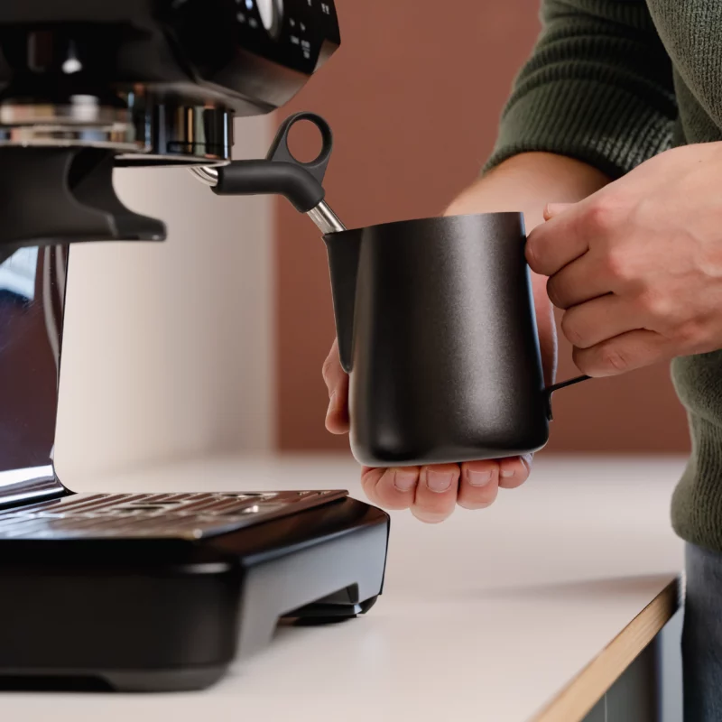 Barista using a Stainless Steel Milk pitcher latte art Essentials 600ml black