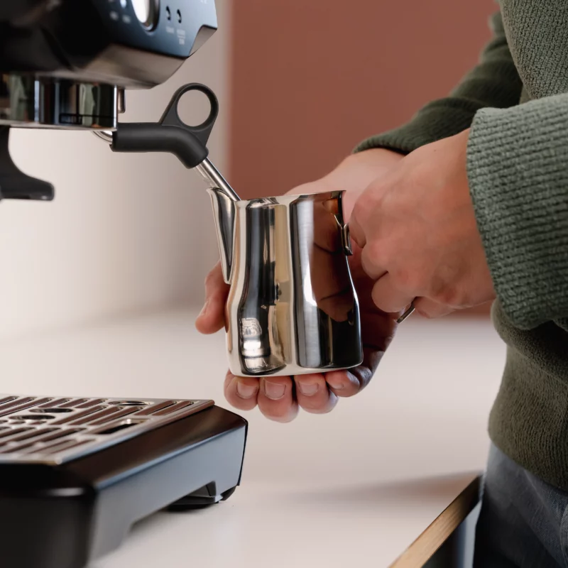 Barista using a Stainless Steel Milk pitcher latte art Essentials 350ml Italian style