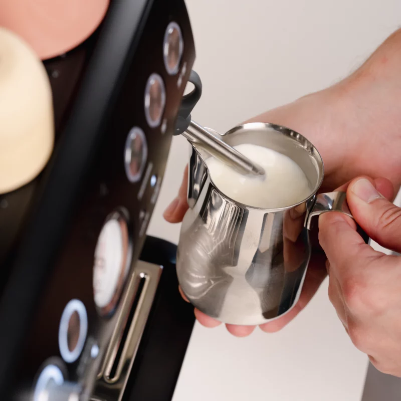 Barista creating milk foam for latte art in Stainless Steel Milk pitcher latte art Essentials 350ml Italian style