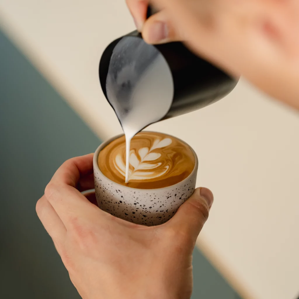 Pouring Latte art in cappuccino coffee cup matte speckled by Barista-Essentials