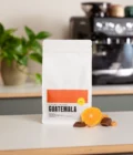 Latte art gift set for home baristas from Barista Essentials. The set contains freshly roasted coffee beans, a cappuccino cup and a milk jug